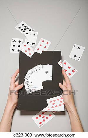 A woman holding a photograph of cards View Large Photo Image Stock Photo - A woman holding a photograph of cards. Fotosearch