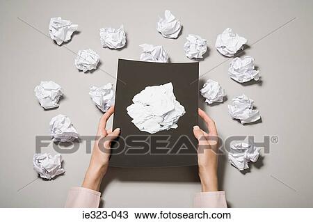 A woman holding a photograph of crumpled paper View Large Photo Image Stock Image - A woman holding a photograph of crumpled paper. Fotosearch