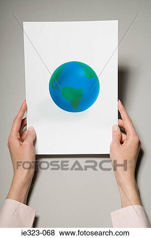 A woman holding a photograph of the earth View Large Photo Image Stock Photo - A woman holding a photograph of the earth. Fotosearch