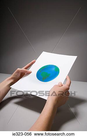 A woman holding a photograph of the earth View Large Photo Image Stock Photograph - A woman holding a photograph of the earth. Fotosearch