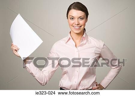 A woman holding a piece of paper View Large Photo Image Picture - A woman holding a piece of paper. Fotosearch
