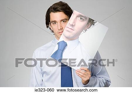 Portrait of a man holding a photograph of himself View Large Photo Image Stock Image - Portrait of a man holding a photograph of himself. Fotosearch