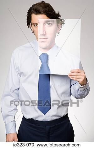 Portrait of a man holding a photograph of himself View Large Photo Image Stock Image - Portrait of a man holding a photograph of himself. Fotosearch