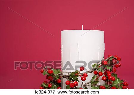 Candle with holly around it View Large Photo Image Stock Photo - Candle with holly around it. Fotosearch