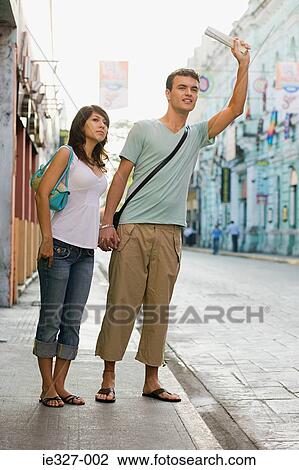Couple hailing a cab View Large Photo Image Stock Image - Couple hailing a cab. Fotosearch