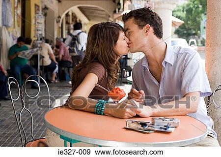 Stock Photo - Couple kissing at cafe. Fotosearch
