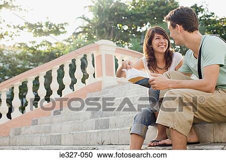 Stock Image - Couple with guidebook. Fotosearch