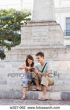 Couple with guidebook View Large Photo Image Stock Image - Couple with guidebook. Fotosearch