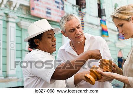 Man and tourists with container View Large Photo Image Stock Photo - Man and tourists with container. Fotosearch