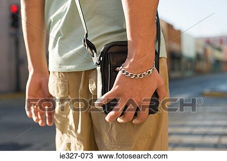 Stock Image - Tourist on street with bag. Fotosearch