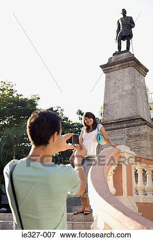Woman being photographed by statue View Large Photo Image Stock Photo - Woman being photographed by statue. Fotosearch