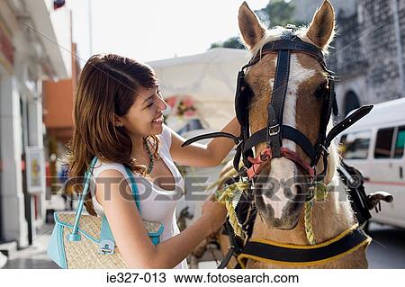 Young woman and horse View Large Photo Image Stock Image - Young woman and horse. Fotosearch