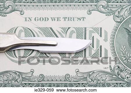 Scalpel and a dollar bill View Large Photo Image Stock Photo - Scalpel and a dollar bill. Fotosearch