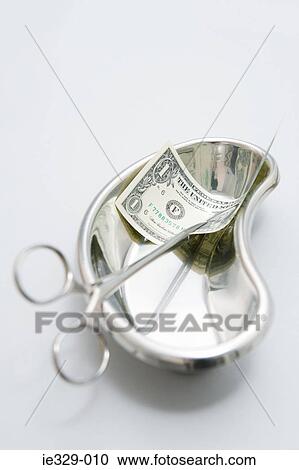 Surgical scissors with a dollar in a bedpan View Large Photo Image Stock Image - Surgical scissors with a dollar in a bedpan. Fotosearch