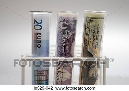 Stock Image - Three banknotes in test tubes. Fotosearch