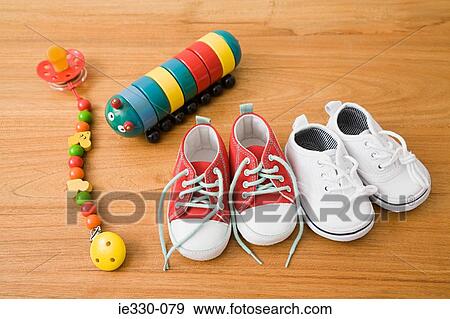 Stock Photo - Baby shoes and toys. Fotosearch