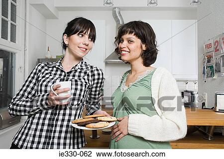 Female friends in the kitchen View Large Photo Image Stock Image - Female friends in the kitchen. Fotosearch