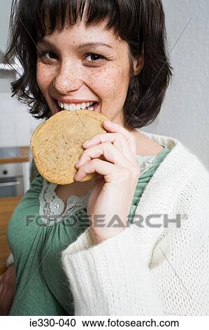 Freckled woman eating a biscuit View Large Photo Image Stock Image - Freckled woman eating a biscuit. Fotosearch