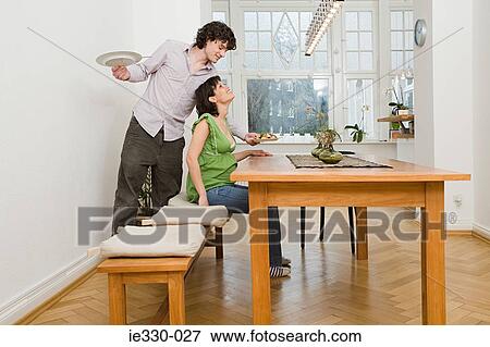 Man serving his partner a meal View Large Photo Image Stock Photo - Man serving his partner a meal. Fotosearch