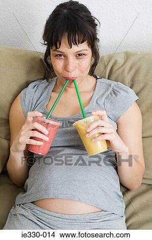 Pregnant woman drinking smoothies View Large Photo Image Picture - Pregnant woman drinking smoothies. Fotosearch