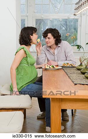 Pregnant woman eating a meal View Large Photo Image Stock Photography - Pregnant woman eating a meal. Fotosearch