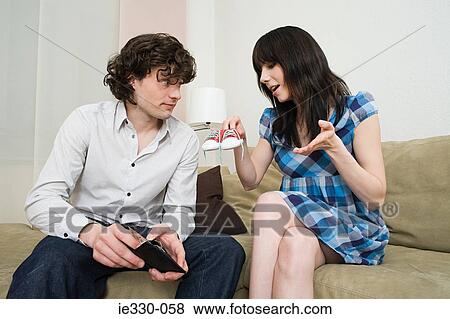 Pregnant woman holding baby shoes View Large Photo Image Stock Photo - Pregnant woman holding baby shoes. Fotosearch