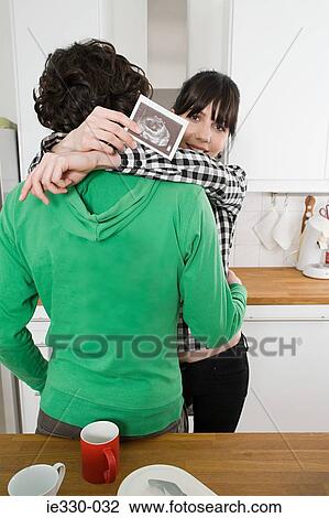 Pregnant woman hugging partner View Large Photo Image Stock Image - Pregnant woman hugging partner. Fotosearch