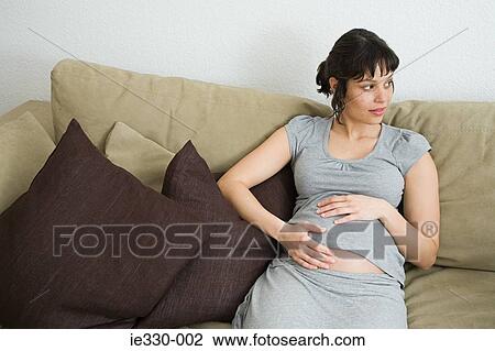 Pregnant woman on a sofa View Large Photo Image Stock Image - Pregnant woman on a sofa. Fotosearch