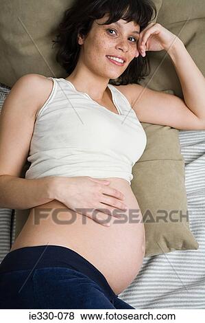 Pregnant woman reclining View Large Photo Image Stock Photo - Pregnant woman reclining. Fotosearch