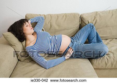 Pregnant woman sleeping on sofa View Large Photo Image Stock Image - Pregnant woman sleeping on sofa. Fotosearch