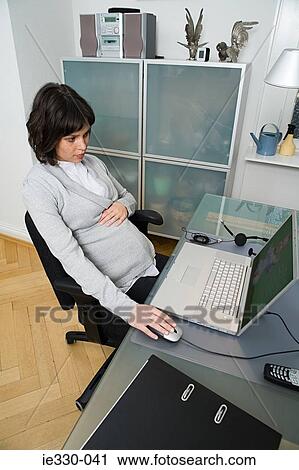 Pregnant woman telecommuting View Large Photo Image Stock Image - Pregnant woman telecommuting. Fotosearch