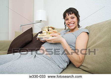 Pregnant woman with a stack of sandwiches View Large Photo Image Stock Image - Pregnant woman with a stack of sandwiches. Fotosearch