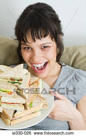Woman with a stack of sandwiches View Large Photo Image Stock Photograph - Woman with a stack of sandwiches. Fotosearch