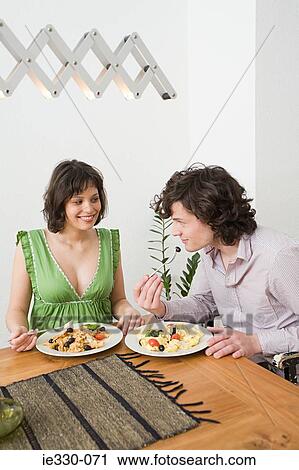 Young couple having a meal View Large Photo Image Stock Image - Young couple having a meal. Fotosearch