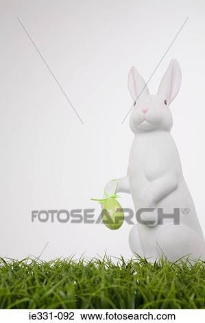 Easter bunny holding an easter egg View Large Photo Image Stock Image - Easter bunny holding an easter egg. Fotosearch
