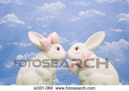 Stock Image - Two rabbits wearing bows. Fotosearch