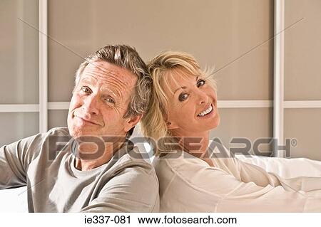 Stock Image - Couple back to back. Fotosearch