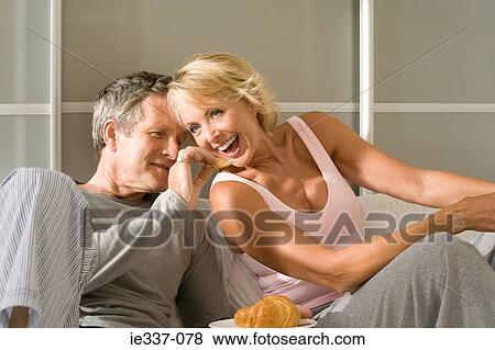 Stock Photo - Couple sharing croissant. Fotosearch