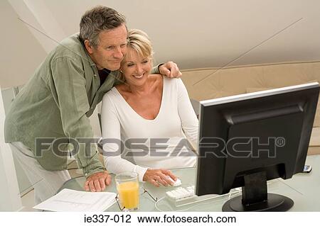 Couple using computer View Large Photo Image Stock Image - Couple using computer. Fotosearch
