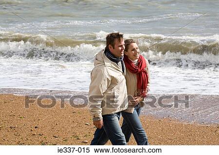Couple walking on the beach View Large Photo Image Stock Photography - Couple walking on the beach. Fotosearch