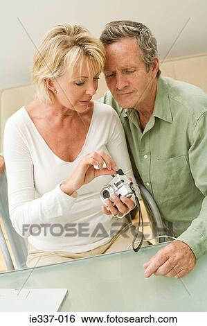 Couple with digital camera View Large Photo Image Stock Photograph - Couple with digital camera. Fotosearch