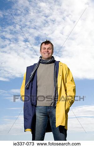Man wearing a raincoat View Large Photo Image Stock Image - Man wearing a raincoat. Fotosearch