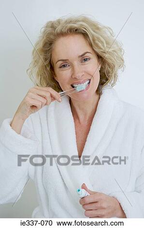 Woman brushing teeth View Large Photo Image Stock Image - Woman brushing teeth. Fotosearch
