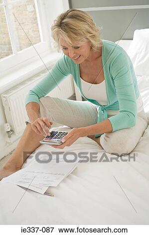 Woman doing home finances View Large Photo Image Stock Photo - Woman doing home finances. Fotosearch