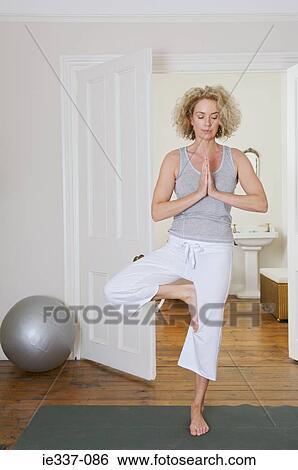 Woman doing yoga View Large Photo Image Stock Photograph - Woman doing yoga. Fotosearch