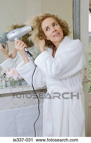 Woman drying her hair View Large Photo Image Stock Image - Woman drying her hair. Fotosearch