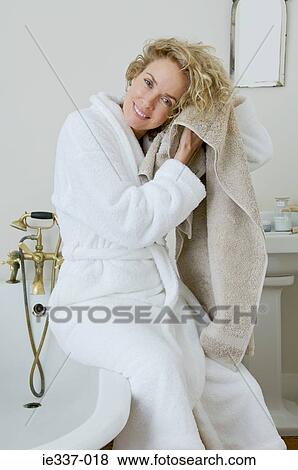 Woman drying her hair View Large Photo Image Stock Photo - Woman drying her hair. Fotosearch