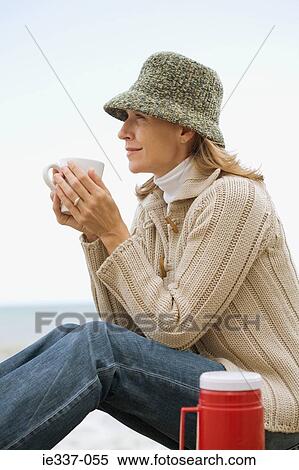 Woman having a hot drink View Large Photo Image Stock Photography - Woman having a hot drink. Fotosearch