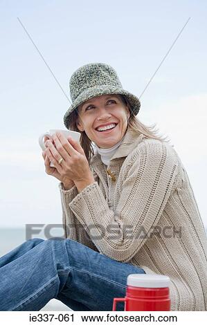 Woman with a hot drink View Large Photo Image Stock Image - Woman with a hot drink. Fotosearch