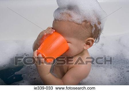 Baby in bath with cup View Large Photo Image Stock Image - Baby in bath with cup. Fotosearch